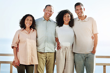 Image showing Portrait, smile and big family by beach on vacation, holiday or trip outdoors. Travel, care and happy grandmother, grandfather and man and woman smiling, having fun or enjoying quality time by ocean.