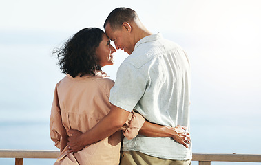 Image showing Love, back and senior couple by beach, hug and enjoying quality time on holiday or vacation. Romance, care and retired happy man and woman hugging, embrace or cuddle while having fun by seashore.