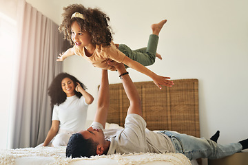 Image showing Airplane, playful and girl playing with father, bonding and quality time together. Smile, happy and dad holding an adorable girl kid for play, fun and caring in the bedroom of a family home with love