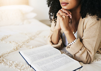 Image showing Bible, prayer and hands praying for hope, religion or help, spiritual or faith in home. God, christian and female or woman worship Jesus Christ or Holy Spirit with catholic text or book for peace.