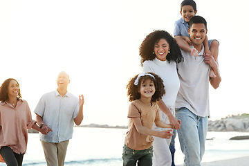 Image showing Beach, family and grandparents, parents and children relax for bonding and walking together at sunset. Travel, love and happy kids with mom and dad by ocean for adventure, holiday and vacation