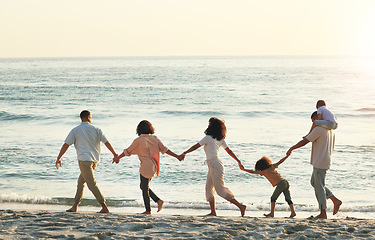 Image showing Big family, walking and holding hands at beach at sunset, having fun and bonding on vacation outdoors. Care, mockup and kids, grandmother and grandfather with mother and father enjoying holiday time