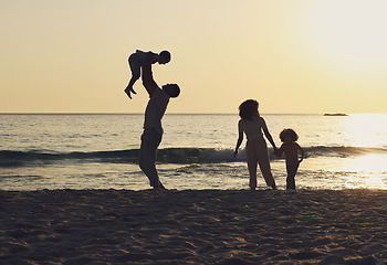 Image showing Sunset, playing and travel with family at beach for freedom, happiness and summer break on vacation. Relax, calm and holiday trip with parents and children enjoying bonding, quality time and care