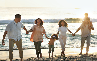Image showing Walking, happy and big family holding hands at the beach for vacation, trust and together in Bali. Travel, sunset and grandparents, children and parents on a walk by the sea for bonding and play