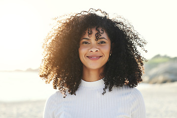 Image showing Black woman, face and portrait at beach for vacation, freedom and smile with natural hair and beauty. Happy young model person outdoor in nature for peace, travel and time to relax on sunset holiday