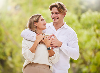 Image showing Park, love and couple with smile outdoor for happy, quality time and bonding on weekend, vacation and holiday. Dating, summer and young man and woman hugging, relax and romantic embrace in nature