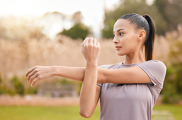 Image showing Health, fitness and woman stretching arms in nature to get ready for workout, training or exercise. Sports, thinking and female athlete stretch and warm up to start exercising, cardio or running.
