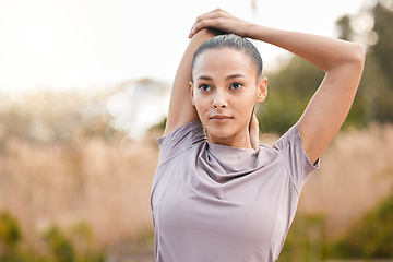 Image showing Sports, fitness and woman stretching arms in nature to get ready for workout, training or exercise. Thinking, health or young female athlete stretch and warm up to start exercising, cardio or running
