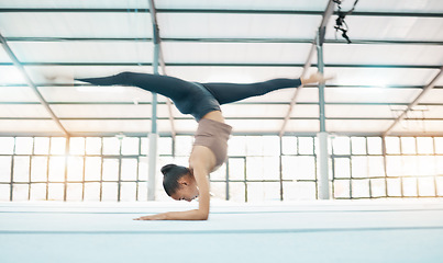 Image showing Fitness, gymnasium and flexibility with a black woman training in a gym for a gymnastics competition. Exercise, workout and balance with a female gymnast in a studio to practice for her performance