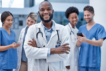 Image showing Black man, doctor and portrait with arms crossed in hospital, clinic and surgery of leadership. Happy medical worker smile for consulting service, expert therapist and trust in healthcare management