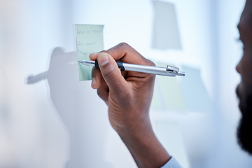 Image showing Black man, hands and writing for schedule planning, brainstorming or tasks on glass board at office. Hand of African American male with pen to write project plan, idea or sticky note for strategy