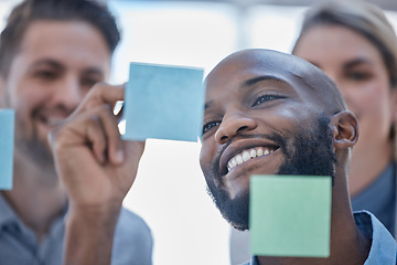 Image showing Black man, writing and smile for schedule planning on glass board for team brainstorming or tasks at office. Happy African male smiling in project plan, ideas or sticky note for teamwork strategy