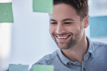 Image showing Creative man, writing and smile for schedule planning on glass board for brainstorming tasks at office. Happy male face smiling in project plan, write or sticky note for company strategy or startup