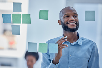 Image showing Black man, writing and planning schedule with smile on glass board for brainstorming tasks at office. Happy African American male smiling in project plan, idea or sticky note for company strategy