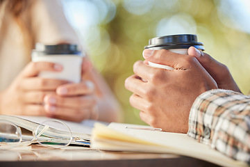 Image showing Couple, coffee and hands outdoor on a date while studying, together and bonding at table. Hand of man and woman students with a drink or tea in disposable cup to relax with love and care at cafe