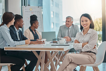 Image showing Asian woman, portrait and arms crossed for leadership in meeting, management or planning at the office. Happy female leader or manager with smile sitting at conference table for team project plan