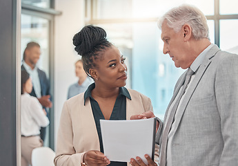 Image showing Documents, discussion and man and black woman talking in office for business proposal, strategy or advice. Collaboration, teamwork and corporate managers meeting for project, report or finance review