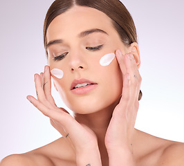 Image showing Beauty, skincare or girl with face cream product in daily grooming treatment with makeup cosmetics in studio. Dermatology, mockup space background or female model applying facial sunscreen lotion