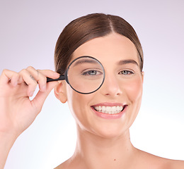 Image showing Magnifying glass, search or woman with beauty, skincare health or natural face grooming routine. Eye wrinkles, zoom of female cosmetic or happy girl model with lens for anti aging facial in studio