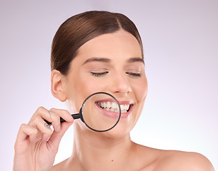 Image showing Magnifying glass, teeth or woman with dental, smile or natural face beauty in oral health hygiene routine. Search, tooth or happy girl model with lens for wellness, clean mouth or treatment in studio