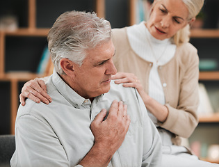 Image showing Heart attack, pain and senior couple at home with cardiology problem or stroke. House, cardiac arrest and retirement of a man with emergency and health issue in a living room with female support