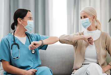 Image showing Covid greeting, mask and nursing home with Asian nurse and senior woman in retirement. Happy, handshake and healthcare clinic with a patient and wellness worker with smile and friendship in hospital