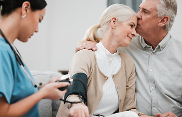 Image showing Kiss, nurse or old couple with blood pressure test consulting in hospital to monitor heart healthcare. Doctor, hypertension consultation or medical physician with a happy patient for examination