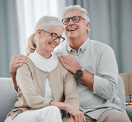 Image showing Laughing, love or funny old couple hugging on house living room sofa together enjoying quality time. Smile, peace or happy mature man bonding with a supportive senior woman in retirement at home