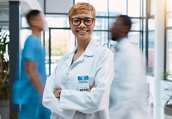 Image showing Portrait, doctor and black woman in a busy hospital standing arms crossed with motion blur. Healthcare, leadership and trust with a female medicine professional in a clinic for health treatment