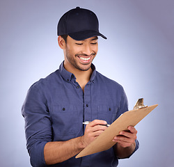 Image showing Man, studio and writing on clipboard working on delivery, shipping and logistics with hat and smile. Happy asian model person or worker on checklist, list or form for information on purple background