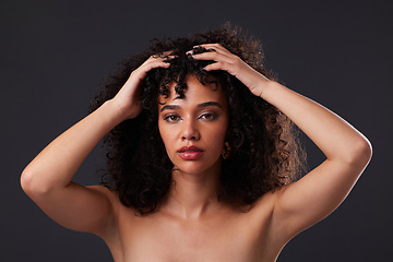 Image showing Portrait, natural and hair by black woman in studio for beauty, treatment and body care on black background. Face, girl and curly afro model relax with luxury, soft and glowing skin while isolated