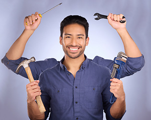 Image showing Handyman, builder tools and portrait of mulitask engineering of a man ready for construction work. Diy, home renovation project and happiness of a model with isolated studio background with arms