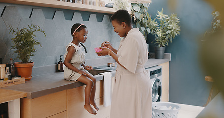 Image showing Mother, child and breakfast with mom feeding girl food for nutrition, growth health and wellness in home kitchen. Black woman with girl at family house for quality time, love and eating healthy