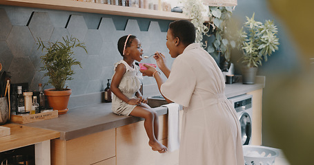 Image showing Family, children and love with a girl and mother playing together in the kitchen of their home. Kids, funny and tickline with a black woman and daughter laughing while bonding in their house