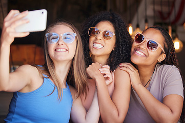Image showing Sunglasses, friends and selfie with women in restaurant for social media, freedom and support. Happy, diversity and photo with group of girls in cafe for picture, networking and relax on weekend
