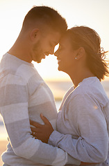 Image showing Couple, sunset and forehead touch for love, outdoor beach date and happy holiday. Young man, woman and face of relationship at ocean for freedom, support and relax with trust, peace and smile of care