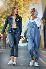 Image showing Friends, diversity and holding hands with women in road for support, spring and travel together. Community, happy and smile with girls walking in street path for muslim, social and solidarity