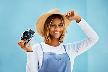 Image showing Happy, camera and photographer with portrait of woman for creative, retro and shooting photos. Fashion, happiness and vintage with girl and photography for picture, lens and blue wall background