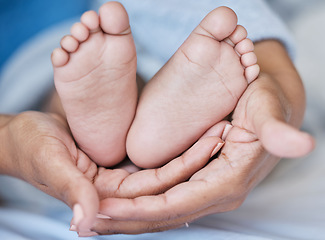 Image showing Hands, feet and baby with mother for love, care and security while together in family home. Woman or mom and child bonding for development, growth or wellness with support, gratitude and protection