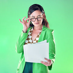 Image showing Woman in glasses reading paper isolated on green background for fashion design career, gen z resume and internship. Young person or model with retro clothes and documents review for job opportunity
