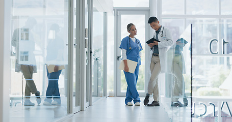 Image showing Healthcare, nurse and doctor talking, walking in lobby and consultation for advice, diagnosis and tablet. Medical professionals, Asian man and woman in hospital, update charts or planning for surgery