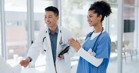 Image showing Doctors handshake, welcome and hospital team with applause, onboarding and kindness for new colleagues. Black woman, asian man and muslim medic in clinic, shaking hands and healthcare collaboration