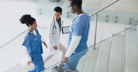 Image showing Talking, busy and doctors walking in hospital or stairs for clinic services, results or healthcare planning of documents. Research, report and nurse or professional medical people advice or strategy