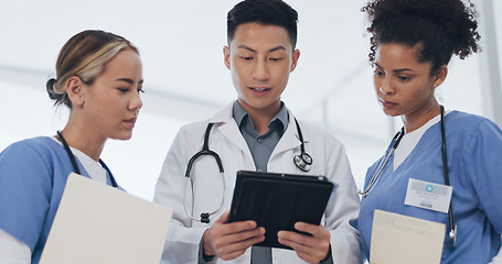 Image showing Asian doctor, nurses and tablet in meeting, surgery planning or low angle feedback in research hospital. Talking, diversity and healthcare people on technology, teamwork and leadership collaboration