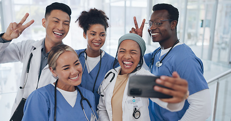 Image showing Doctors, team and selfie with diversity and health group, happiness with collaboration and smartphone photography. Medical professional, happy in picture and people in medicine with peace hand sign