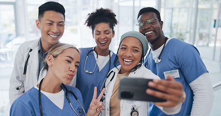 Image showing Doctors, team and selfie with diversity and health group, happiness with collaboration and smartphone photography. Medical professional, happy in picture and people in medicine with peace hand sign