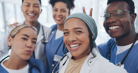 Image showing Doctors, friends and selfie in hospital for team building, solidarity or diversity for social media post. Doctor, group and teamwork with black man, women and peace for comic smile, happy and support