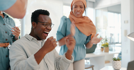 Image showing Success, good news and team in celebration in the office for achievement, teamwork or goal on laptop. Diversity, celebrate and happy business people celebrating successful collaboration in workplace.