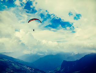 Image showing Paraplane in sky above mountains