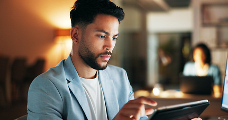 Image showing Confident business planning a marketing strategy on a digital tablet while working in a modern office. Young professional using an online app to manage time and balance his tasks, a list for success